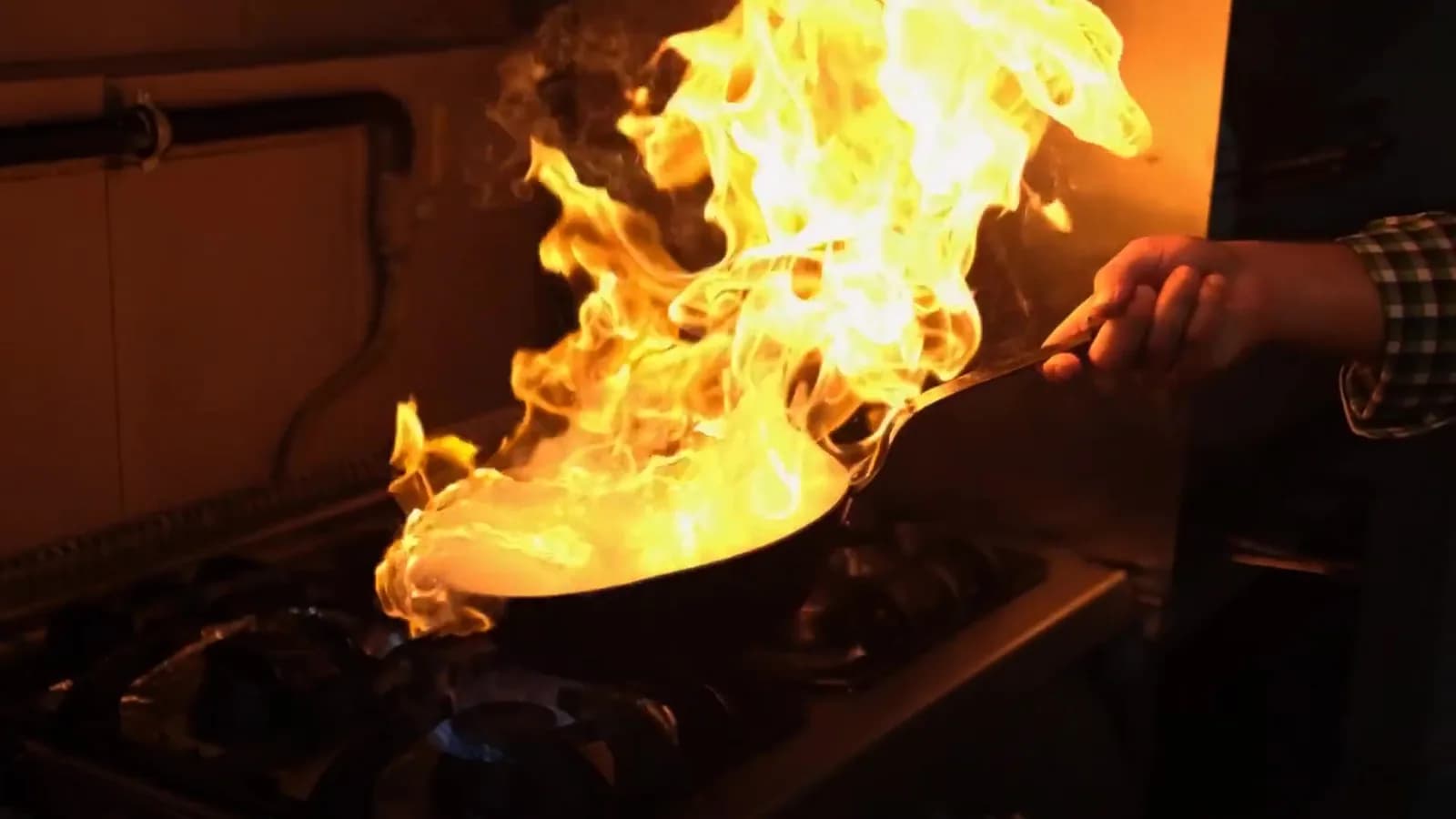 Hero imagery from the TASSIE FLAME website featuring restaurant cooking with flame