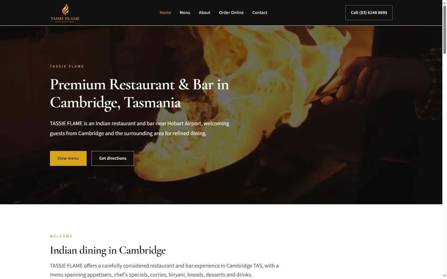 Screenshot of the TASSIE FLAME homepage showing the restaurant hero and navigation